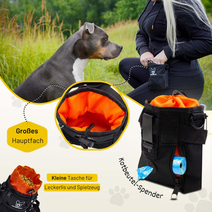 Kleiner Futterbeutel von Hundefreund in Schwarz-Orange, Hund nimmt ein Leckerli